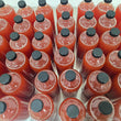 Load image into Gallery viewer, Multiple clear bottles filled with a bright liquid, arranged tightly together and viewed from above. Each bottle has a black screw cap, and the bottles are packed closely with only small gaps visible between them.
