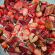 Load image into Gallery viewer, Chopped fresh strawberries and rhubarb pieces mixed together in a clear container with apple cider vinegar.
