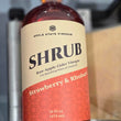 Load image into Gallery viewer, A bottle of Apple State Vinegar Strawberry &amp; Rhubarb Shrub, featuring a cream and red label with black text, set against a blurred background.
